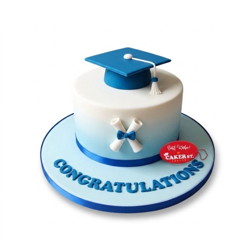 Single-tier graduation cake with blue mortarboard, diplomas, and "CONGRATULATIONS" message.