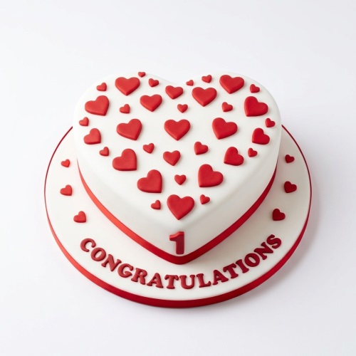 White heart-shaped cake with red fondant hearts, red ribbon, and a customisable number.