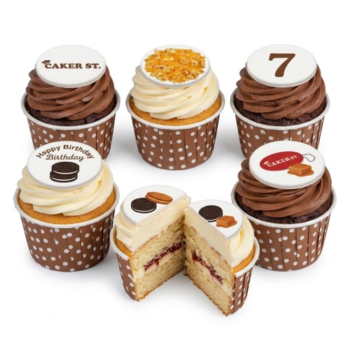 Assorted kids birthday cupcakes with chocolate and vanilla frosting, cookie, caramel, and custom age toppers.