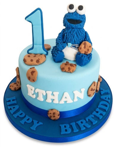 Light blue single-tier cake with a Cookie Monster figure, number '1' topper, and cookie decorations.