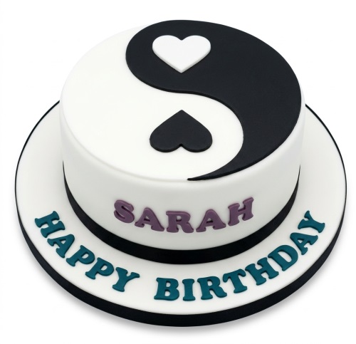 Round white cake with black and white Yin Yang symbol, heart accents, and custom message.