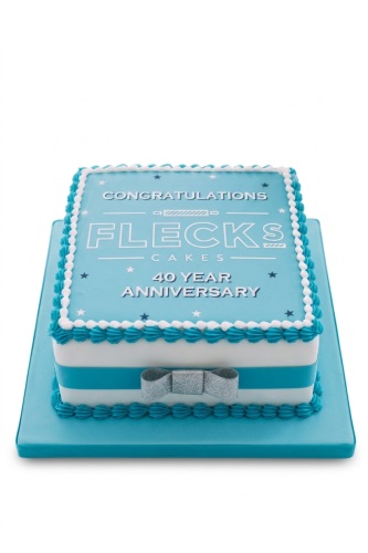 Square blue and white anniversary cake with a silver bow and star details.