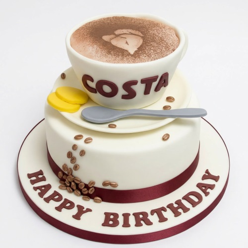 Two-tier Costa Coffee themed birthday cake with a 3D coffee cup, coffee beans, and 'Happy Birthday' message.