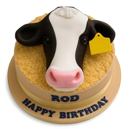 Round birthday cake with a 3D black and white cow head, hay-like texture, and a yellow ear tag.