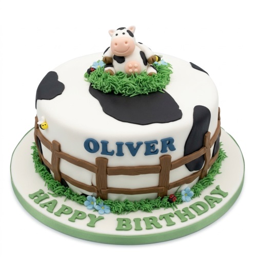 Round white and black cow print cake with a 3D fondant cow, fence, bee, and ladybug decorations.