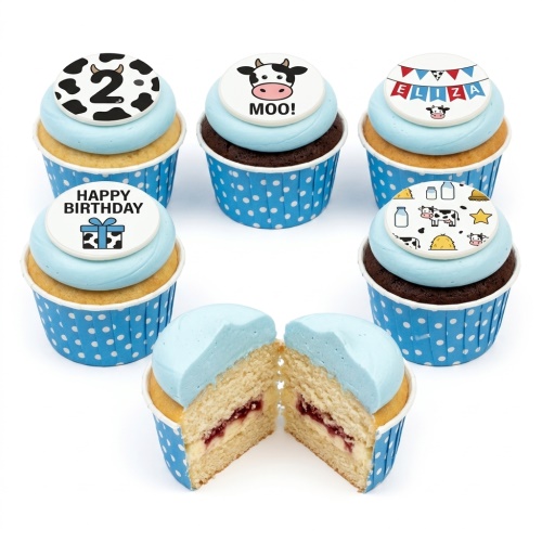 Close-up of blue frosted cupcakes with cow and farm themed edible toppers, including a custom age '2' and 'Happy Birthday' message.