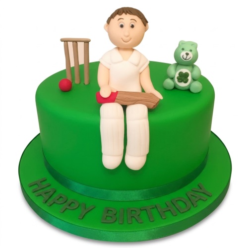 Round green cricket birthday cake with cricketer figurine, stumps, ball, and green teddy bear.