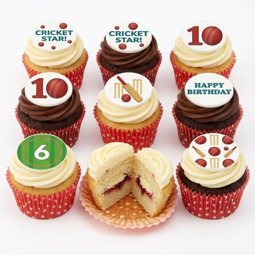 A set of nine cricket-themed cupcakes with red polka dot cases, featuring edible toppers with cricket bats, wickets, balls, and messages like "CRICKET STAR!" and "HAPPY BIRTHDAY", plus custom age numbers. One cupcake is cut open showing a vanilla sponge with jam filling.
