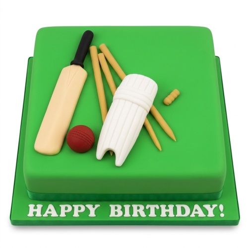 Square green cake with edible cricket bat, ball, stumps, and pad decorations.