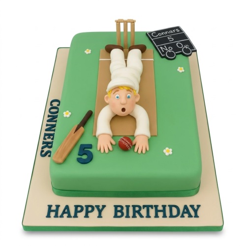 Green cricket pitch birthday cake with upside-down player, bat, ball, stumps, and custom age.
