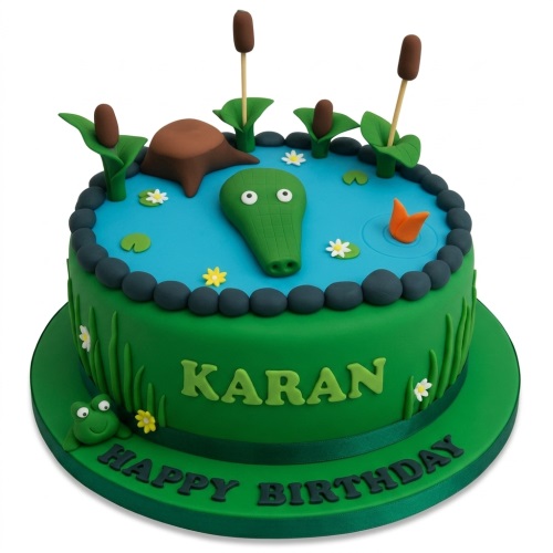 Green jungle theme birthday cake with a crocodile in a pond, frog, and personalised message.