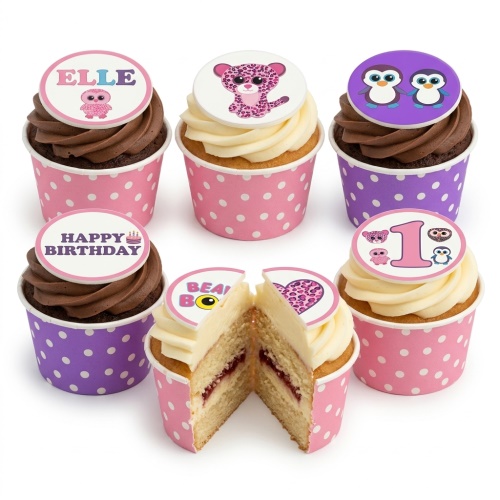 Assortment of Beanie Boo character cupcakes in pink and purple polka dot cases with chocolate and vanilla frosting.