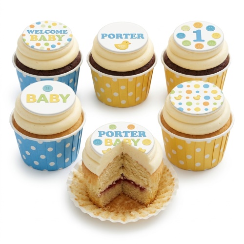 Baby shower cupcakes with polka dot wrappers, buttercream, and customisable toppers featuring ducks, buttons, and 'Welcome Baby' message.