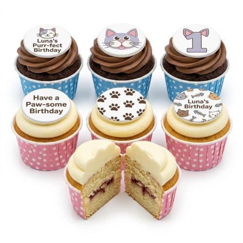 Assortment of cat-themed birthday cupcakes with various toppers, including cat faces, paw prints, and birthday messages.