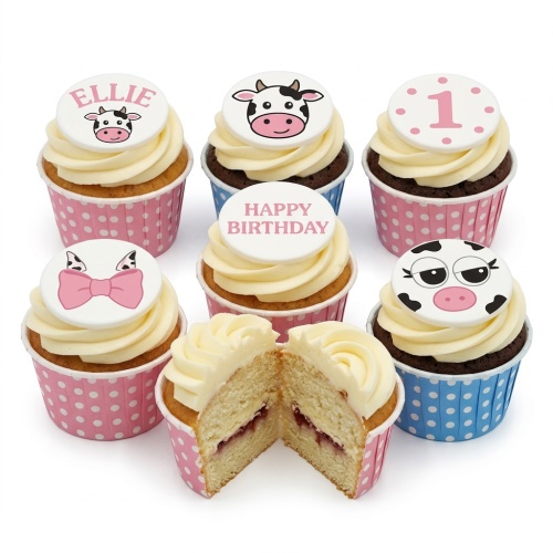 Six cupcakes with cream frosting, cow face toppers, a pink bow, and 'Happy Birthday' and '1' messages.