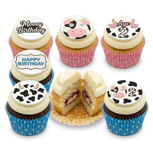 Six cow themed birthday cupcakes with white frosting, cow faces, cow print, and custom age topper.