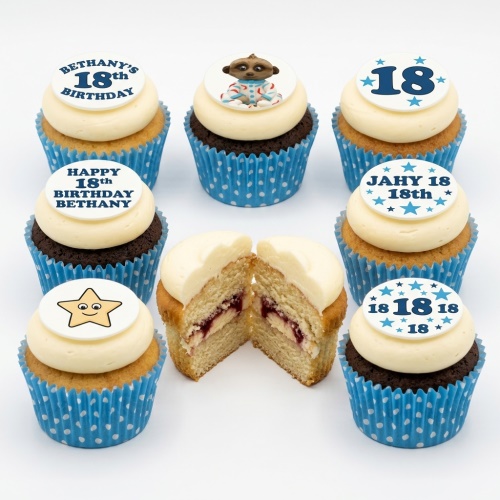 A selection of personalised birthday cupcakes with meerkat, star, and custom age toppers on white and chocolate sponges in blue polka dot cases.