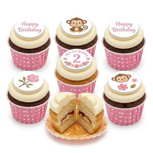 Assortment of monkey and floral themed birthday cupcakes with custom age topper and 'Happy Birthday' messages.
