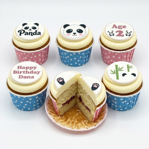 Panda theme birthday cupcakes with white frosting, panda faces, paw prints, and bamboo toppers in pink and blue cases.