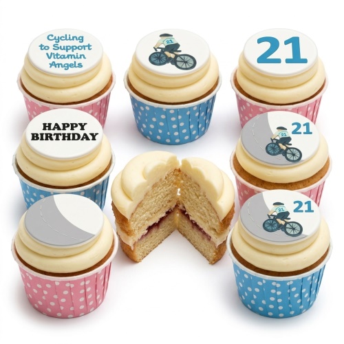 Cupcakes with white frosting, cycling theme toppers, and custom age in blue and pink wrappers.
