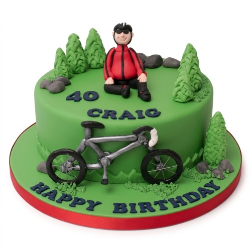 Green fondant cake with cyclist figure, bicycle, trees, rocks, and custom age and name