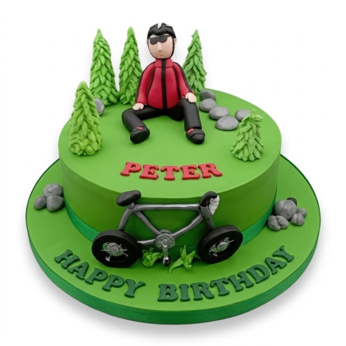 Green single-tier birthday cake with a fondant figure of a man in cycling gear, a bicycle, and pine trees.