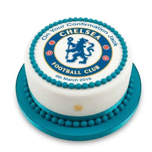 Round white cake with Chelsea FC logo, blue edible pearls, and blue ribbon.