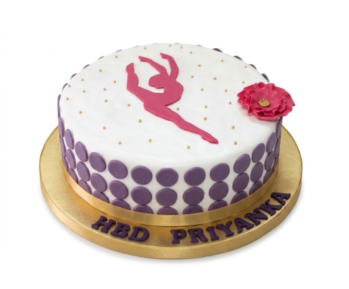 White round cake with pink gymnast silhouette, purple polka dots, pink flower, and gold accents.