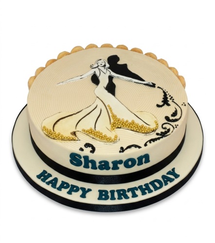Round cream birthday cake with a black and white dancing couple, gold pearls, and a black ribbon.