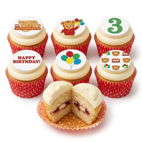 Vanilla cupcakes with white frosting, Daniel Tiger's Neighborhood toppers, balloons, and a custom age topper