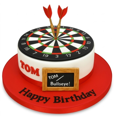 Round white cake with a darts board on top, two red darts, and a personalised message plaque.