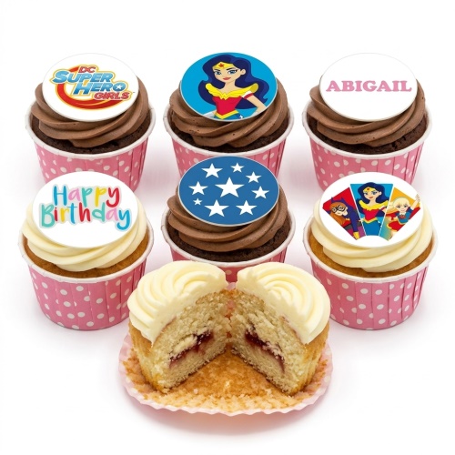 Assorted DC Super Hero Girls cupcakes with chocolate and vanilla frosting, featuring Wonder Woman, Batgirl, Supergirl, and a 'Happy Birthday' message.