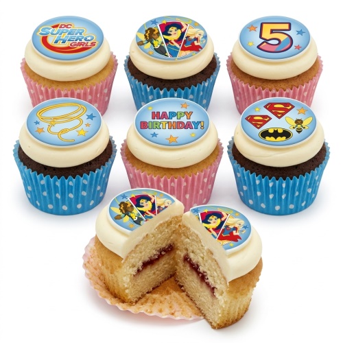 Set of DC Super Hero Girls themed cupcakes with white frosting, blue and pink cases, and edible superhero toppers.