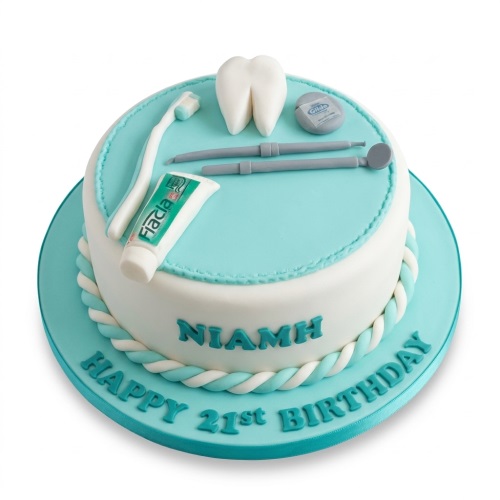 Round white and blue cake with edible dental tools, tooth, toothbrush, and toothpaste.