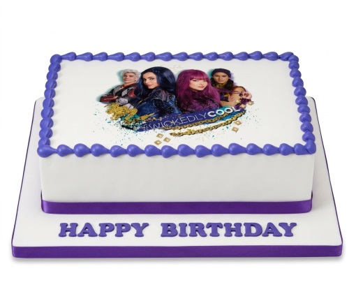 Two-tier white birthday cake with purple trim, featuring an edible image of Disney Descendants characters and 'WICKEDLY COOL' text on top, and 'HAPPY BIRTHDAY' on the base.
