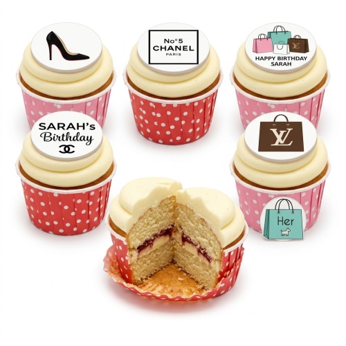 Cupcakes with designer fashion themed toppers including a black high heel, Chanel No. 5 logo, Louis Vuitton shopping bag, and various shopping bags.