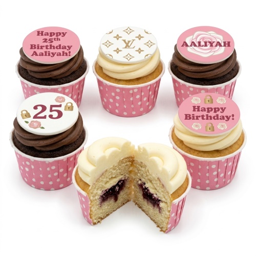Pink and white designer-inspired birthday cupcakes with custom age and name toppers, featuring Louis Vuitton pattern and rose details.