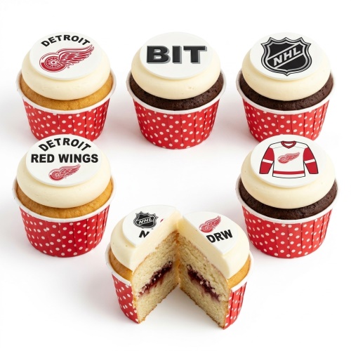 Hockey themed cupcakes with Detroit Red Wings and NHL logos on white frosting, in red polka dot wrappers.