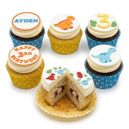 Dinosaur themed birthday cupcakes with custom age and name toppers, featuring orange, blue, and red dinosaurs.