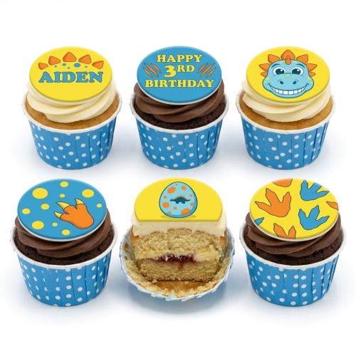 A set of dinosaur themed birthday cupcakes with blue and yellow toppers, some showing a custom age and name.