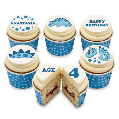 Set of six vanilla cupcakes with white frosting and blue polka dot wrappers. Toppers feature blue cartoon dinosaurs, a custom age '4', and a personalised name 'Anastasia'.