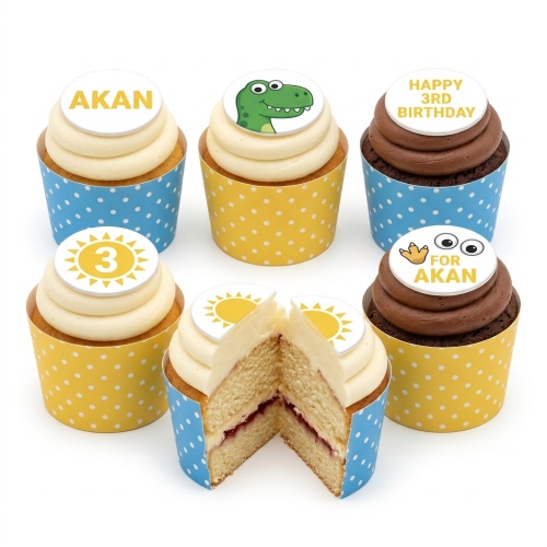 Dinosaur themed birthday cupcakes with custom age and name toppers, yellow and blue polka dot wrappers.