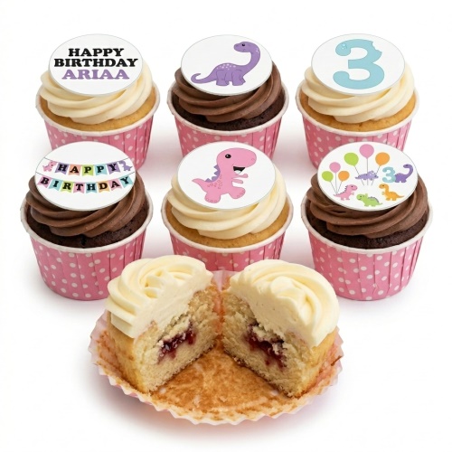 Dinosaur themed cupcakes with pink and purple dinosaurs, a custom age topper, and a 'Happy Birthday' banner.