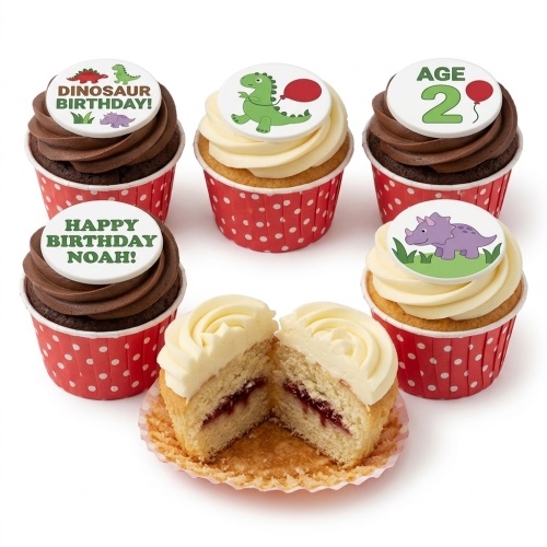 Six cupcakes with dinosaur themed toppers and red polka dot cases, some with chocolate and some with vanilla frosting.