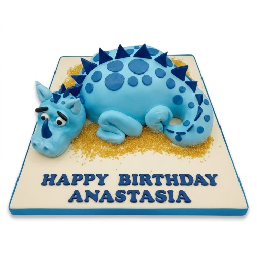 Blue 3D dinosaur birthday cake with spikes and spots, on a gold sprinkle base.