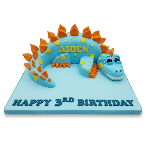 Blue 3D dinosaur birthday cake with orange spikes and yellow spots on a light blue board.