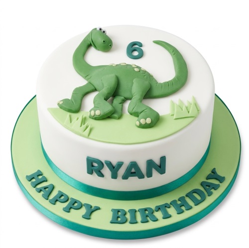 White round cake with a green 3D dinosaur, grass details, and a custom age topper.