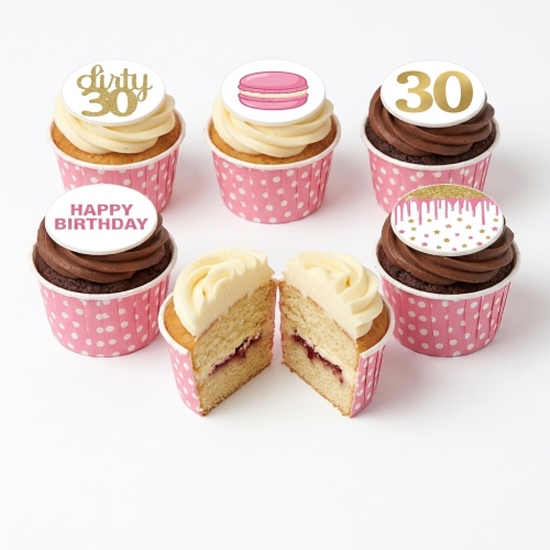 Pink and gold ladies birthday cupcakes with custom age, macaron, and drip toppers.