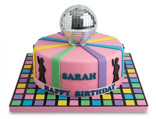Pink round birthday cake with a silver disco ball topper, colourful stripes, and black dancing silhouettes on a multi-coloured square dance floor cake board.