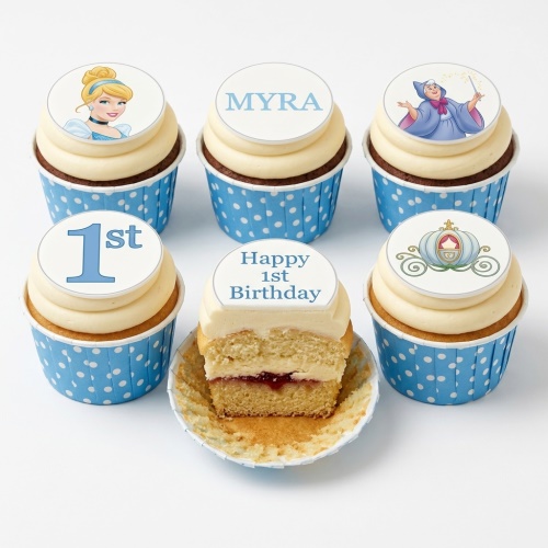 Cinderella princess cupcakes with custom age and name toppers in blue and white wrappers